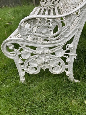 Lot 1556 - Victorian style white painted cast metal garden bench with lily pad and foliate design, 131cm wide.