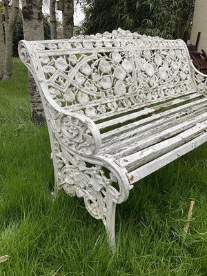 Lot 1556 - Victorian style white painted cast metal garden bench with lily pad and foliate design, 131cm wide.