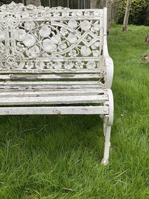 Lot 1556 - Victorian style white painted cast metal garden bench with lily pad and foliate design, 131cm wide.