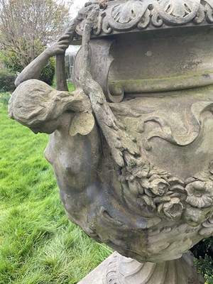 Lot 1557 - A fine antique reconstituted stone garden urn and cover on plinth, with detachable lid, female caryatid handles, floral festoons on socle base, the plinth with figures and acanthus leaves, approxim...