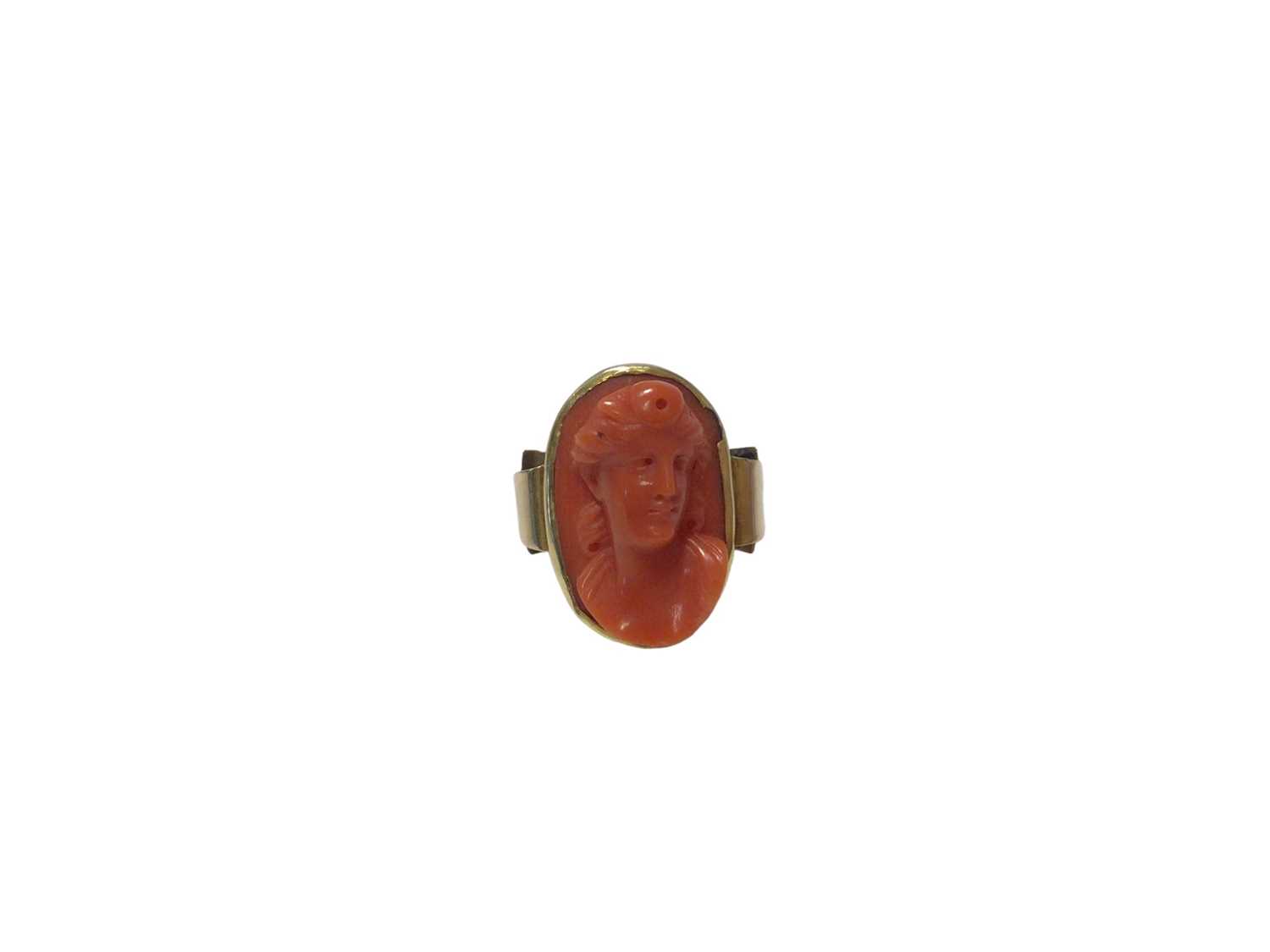 Lot 575 - Antique Italian carved coral cameo depicting a classical female bust, measuring approximately 21.5 x 13.8mm, in gold rub over setting on gold shank, ring size Q½.
