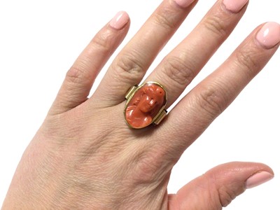 Lot 575 - Antique Italian carved coral cameo depicting a classical female bust, measuring approximately 21.5 x 13.8mm, in gold rub over setting on gold shank, ring size Q½.