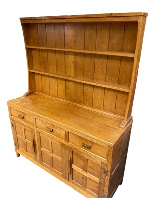 Lot 1529 - Suite of Derek 'Fishman' Slater blond oak dining furniture, comprising high dresser, adzed refectory table and set of six chairs (including two carvers) and hostess trolley (converting to two cof...
