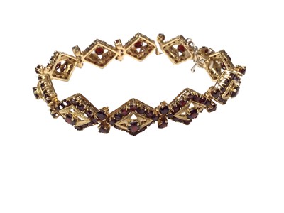 Lot 5 - Victorian style 18ct gold garnet bracelet with pierced panel decoration