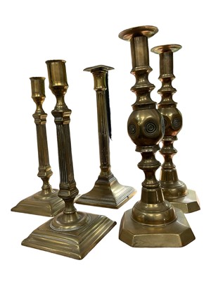 Lot 143 - Pair of George III brass candlesticks, another and pair of Victorian candlesticks