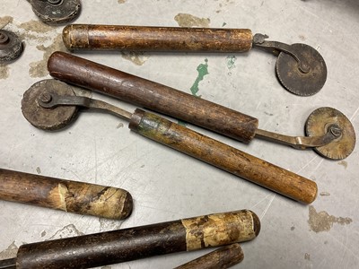 Lot 1532 - Set of 19th century leather working revolving stamps, designed for tooling leather furniture surfaces, approximately 23