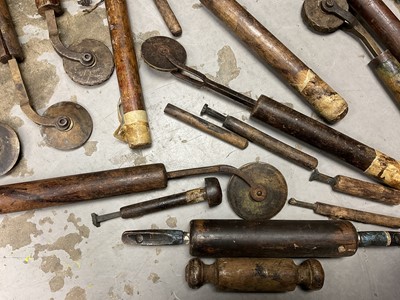 Lot 1532 - Set of 19th century leather working revolving stamps, designed for tooling leather furniture surfaces, approximately 23