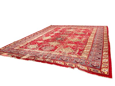 Lot 1425 - Antique Heriz style carpet, with angular medallions on brick red ground, in meander borders, approximately 380 x 470cm