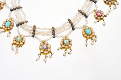 Lot 568 - A fine antique Indian gold seed pearl and gem-set necklace with thirteen flower head clusters, each with a coloured gemstone to include rubies, sapphires, emeralds and turquoise, suspended from see...