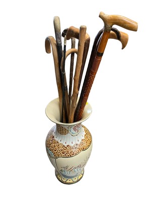 Lot 191 - Walking sticks in a pottery vase