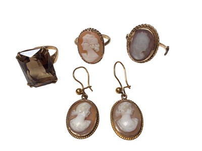 Lot 77 - 9ct gold carved shell cameo ring, one other yellow metal broken cameo ring, a pair of yellow metal cameo pendant earrings and a 9ct gold smoky quartz cocktail ring