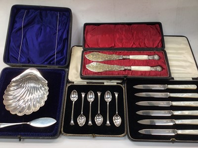 Lot 1086 - Silver shell butter dish and knife, set of six silver coffee spoons, set of six silver and mother of pearl fruit knives and a plated pair of knives, all in cases