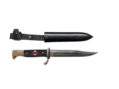 Lot 988 - Unusual 1930's / 40's Nazi German Hitler Youth dagger with two piece checkered plastic grip with inset enamel badge and polished steel Bowie type blade with WKC mark, in black enamelled sheath with...