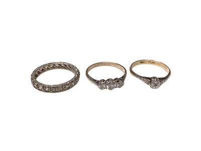 Lot 159 - 18ct gold diamond single stone ring in platinum setting, gold synthetic three stone ring in platinum setting and 9ct white gold synthetic white stone eternity ring (3)