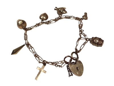 Lot 83 - 9ct gold charm bracelet with seven 9ct gold charms and a padlock clasp