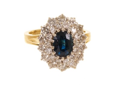 Lot 528 - Sapphire and diamond cluster ring