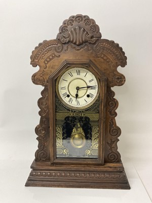 Lot 84 - Late 19th century American clock by the Ansonia Clock Co. with 8 day striking movement in 'gingerbread' wooden case, with pendulum. Height 57cm.