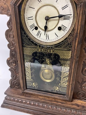 Lot 84 - Late 19th century American clock by the Ansonia Clock Co. with 8 day striking movement in 'gingerbread' wooden case, with pendulum. Height 57cm.