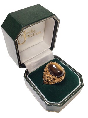 Lot 99 - 1970s tiger's eye cabochon ring in a 9ct gold textured naturalistic claw setting, size O½