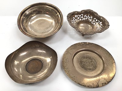 Lot 1067 - Two silver coin dishes, a silver bowl and a pierced silver basket (4)