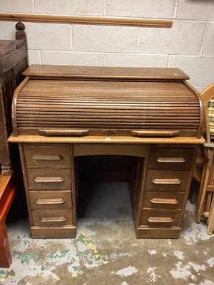 Lot 1330 - 1920s light oak twin pedestal roll-top desk enclosed by tambour shutter with six drawers and a 1920s light oak desk chair (2)