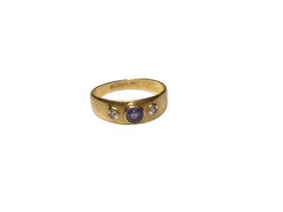 Lot 227 - 22ct gold wedding ring set with a round mixed cut sapphire flanked by two brilliant cut diamonds in a collet setting