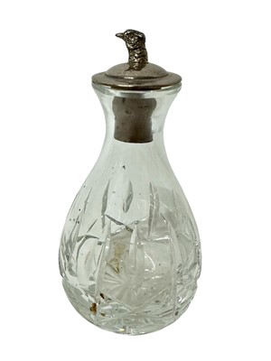 Lot 946 - Silver topped glass bitters bottle with a pheasant head pourer (Birmingham 1965) 12cm high