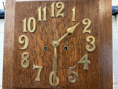 Lot 263 - Art Deco oak wall clock with applied brass numerals, in working condition (with key and pendulum)
