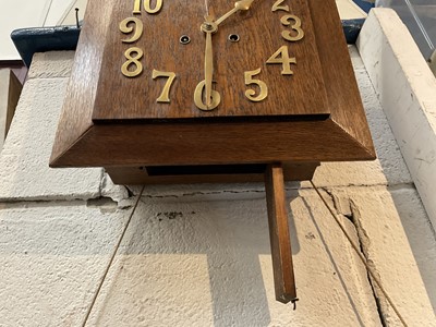 Lot 263 - Art Deco oak wall clock with applied brass numerals, in working condition (with key and pendulum)
