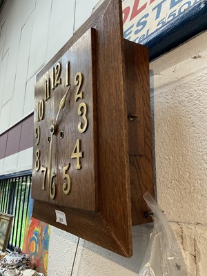 Lot 263 - Art Deco oak wall clock with applied brass numerals, in working condition (with key and pendulum)