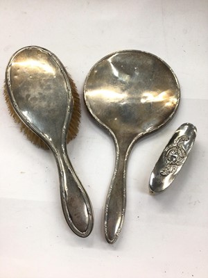 Lot 1097 - Silver backed hand mirror and brush, together with a small plated brush