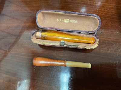 Lot 638 - 9ct gold mounted amber cheroot and another cheroot (2)