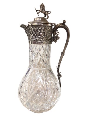 Lot 340 - Cut glass claret jug with silver plated mounts and a lion holding a shield terminal