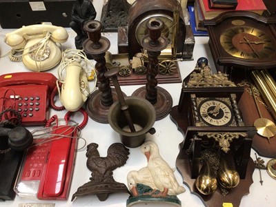 Lot 335 - Group of vintage telephones, three wooden clocks, pair of barley twist candlesticks, box of brassware and sundries