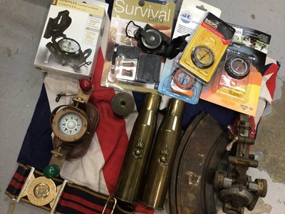 Lot 341 - Pair of brass shell cases, The Royal Logistic Corps belt, gun magazine, two Union Jack flags and a selection of compasses, some new in packets