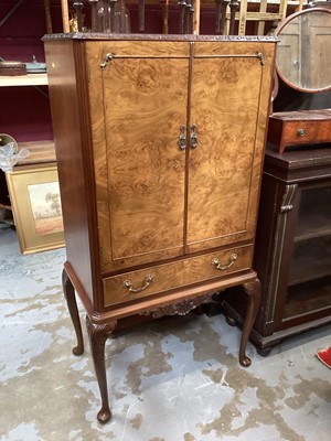 Lot 1207 - Queen Anne-style walnut cocktail cabinet with mirrored interior , two doors and drawer below on carved cabriole legs 70 cm wide, 138cm high, 45cm deep