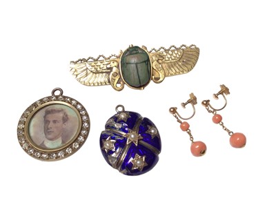 Lot 111 - Egyptian revival yellow metal winged brooch mounted with a carved stone scarab beetle, together with two antique locket pendants with glazed compartments and a pair of antique 9ct gold coral bead s...