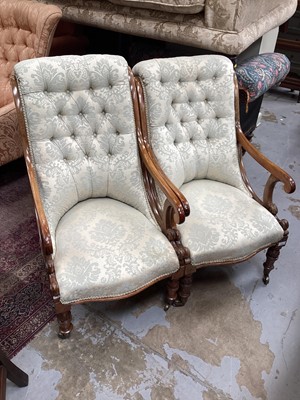 Lot 1292 - Two Victorian mahogany framed armchairs with buttoned upholstery on turned front legs and brass capped castors, 95cm high