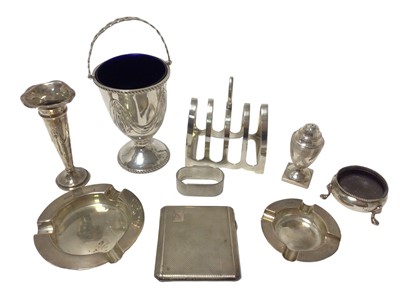 Lot 412 - Group of silver items including pedestal sugar with blue glass liner, ash trays, cigarette case, toast rack, spill vase, pepperette, napkin ring, cauldron salt