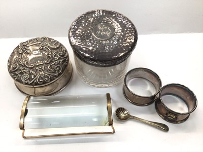 Lot 1044 - Silver jewellery box, silver topped glass powder pot, one silver napkin ring, another plated, a plated salt spoon and a gilt metal mounted magnifying glass 'Ezy Read'