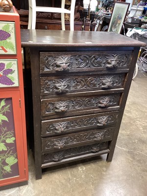 Lot 1352 - Carved oak narrow chest of six drawers with mask handles, 76cm wide, 43cm deep, 108cm high