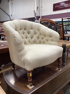 Lot 1365 - Victorian tub chair with buttoned cream upholstery on turned front legs and castors