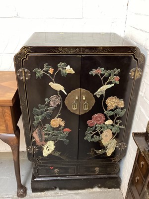 Lot 1393 - Oriental black lacquered two door cabinet with applied soapstone decoration and two drawers below, 66.5cm wide, 41cm deep, 108cm high