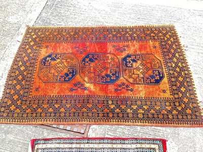 Lot 1414 - Eastern rug with three central medallions on burnt orange ground, 150cm x 100, together with three other rugs (4)