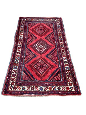 Lot 1421 - Eastern rug with three central medallions on red, blue and cream ground, 186cm x 99cm