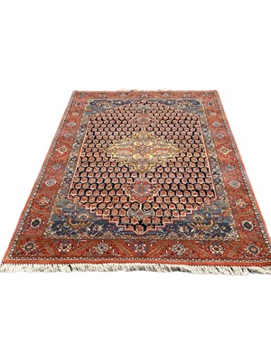 Lot 1424 - Eastern rug with central medallion on red and blue ground, 220cm x 110cm