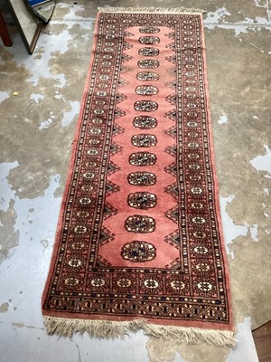 Lot 1442 - Eastern runner with a row of 14 medallions on pink ground, 182cm x 62cm