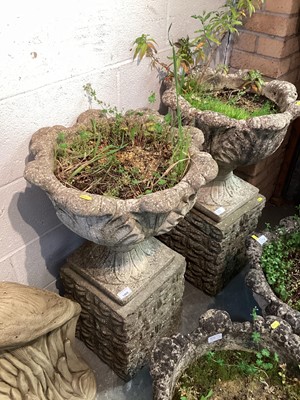 Lot 1469 - Pair of concrete garden urns on plinth bases, 79.5cm high