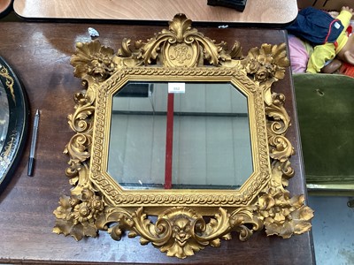 Lot 552 - Antique carved giltwood decorative hanging mirror with central crest containing initials.