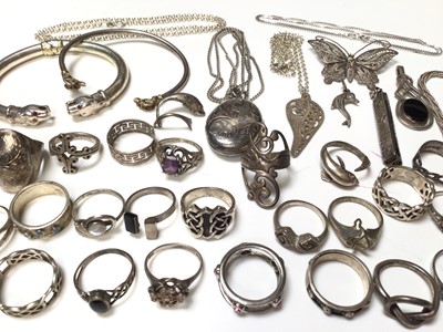 Lot 127 - Group of silver and white metal rings, two torque bangles with animal head terminals, silver chains, pendants etc